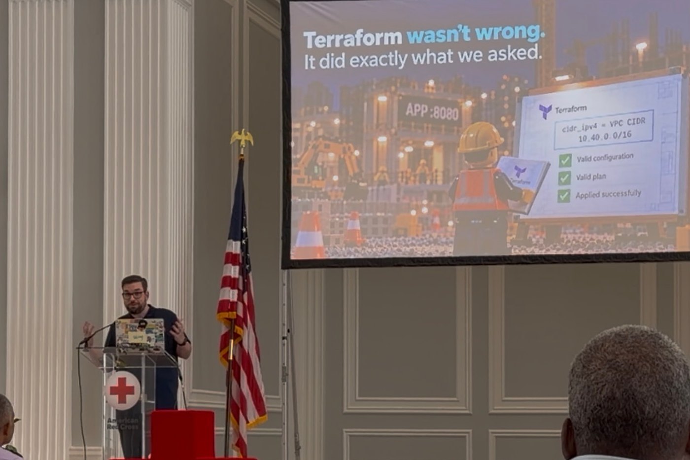 Brian Teller speaking at DC State of the Stack 2026, at a lectern beside a screen reading "Terraform wasn't wrong. It did exactly what we asked."
